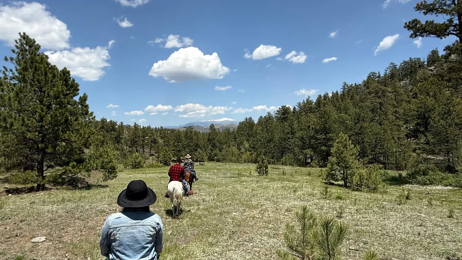 Riders crossing open country near Guffey.