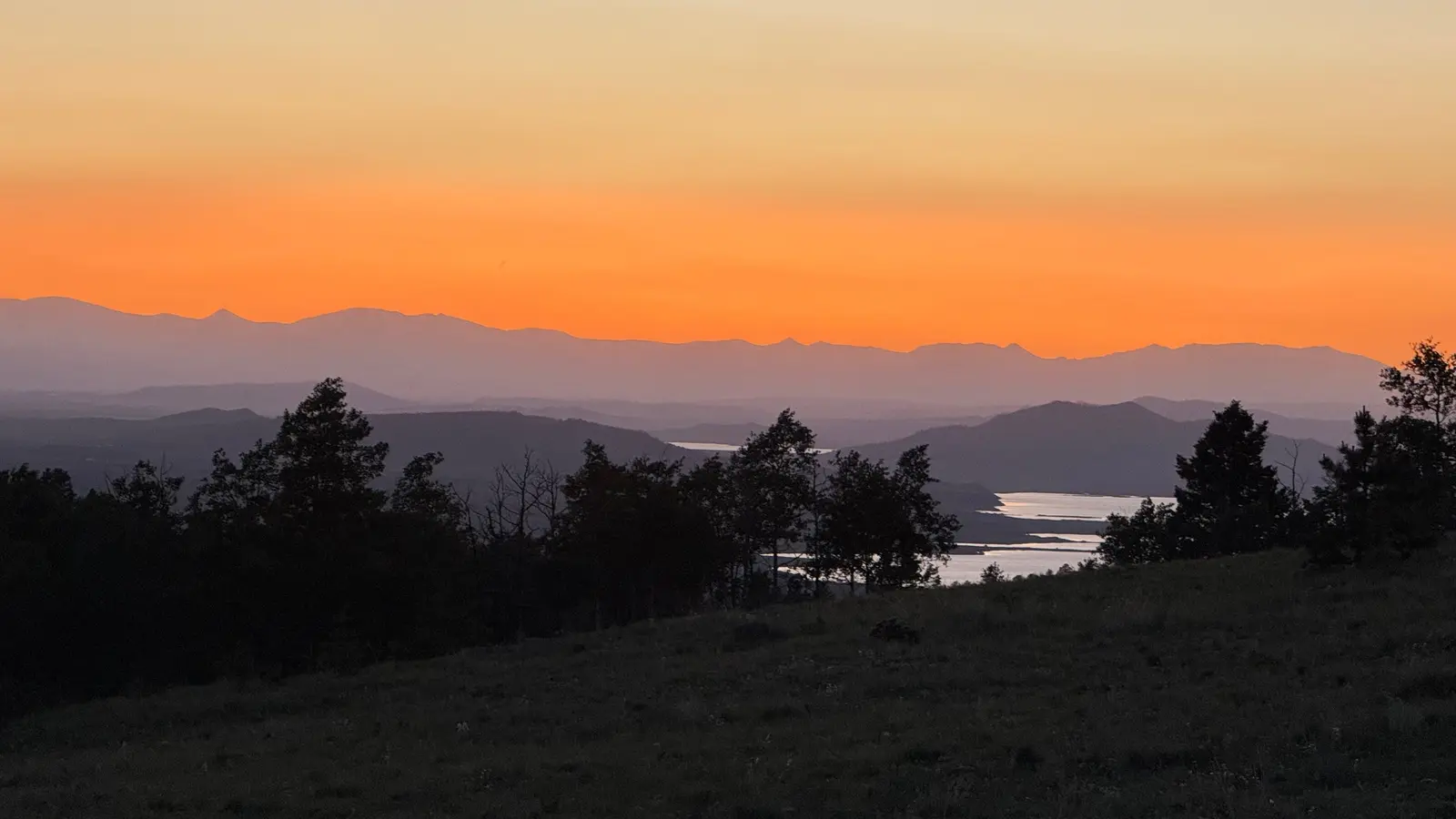 A fiery sunset over the distant mountains.